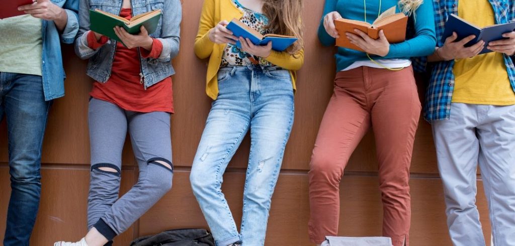 Students standing and holding books